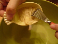 Ceramic grater-raking it into the bowl